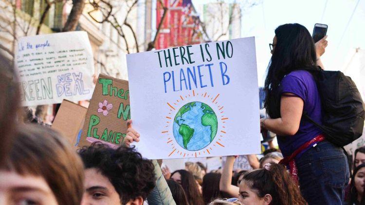 Climate change protest with 'there is no planet b' poster