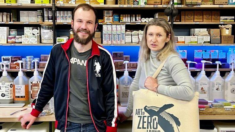 Man and woman standing in their eco-friendly store (Art of Zero Living) in front of a variety of products
