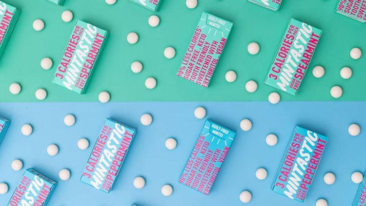 sweet mints packets with background of pastel green and blue and some white mints tablets all around