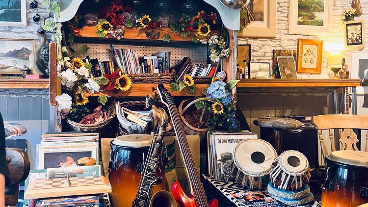  Interior of Cosy Jazz Café in Blackpool, with a variety of instruments, books, paintings and flowers