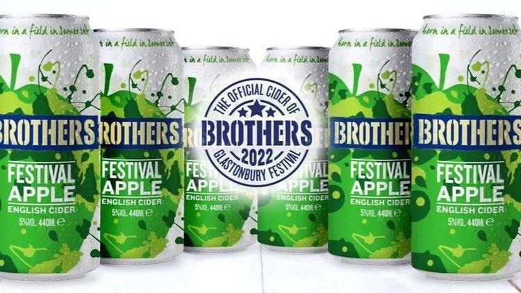 Six green and white cans of Brothers Festival Apple Cider