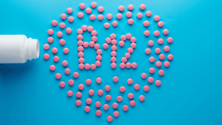  B12 spelled out with pink B12 pills on a blue background