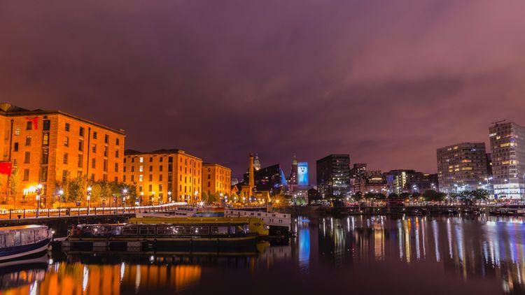 Liverpool docks illuminated by lights in the evening 