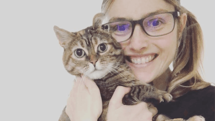 Lexy Goode (owner of The Goode Life UK) smiling and holding a cat